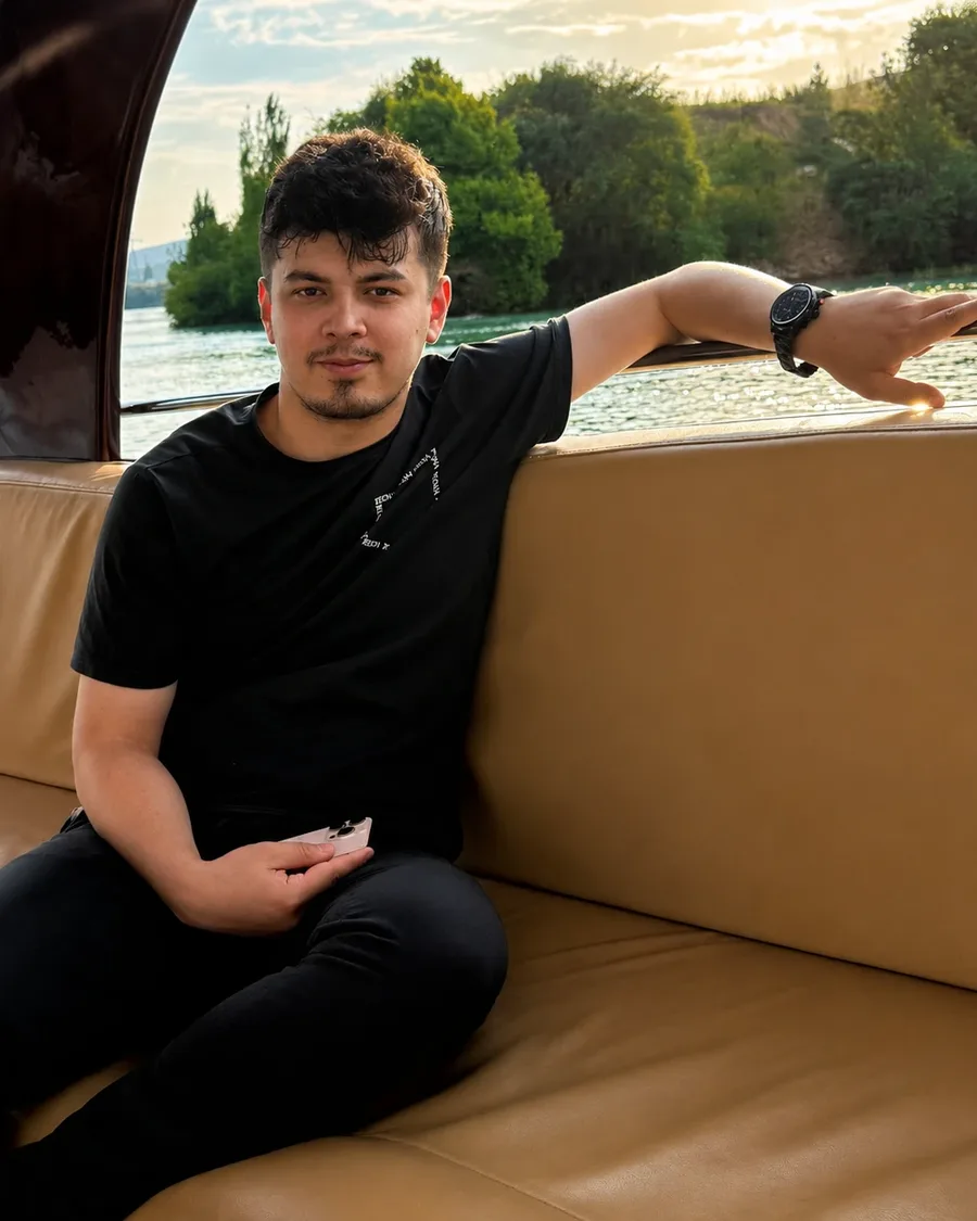 Muhammad Ergashev on a boat, at sunset